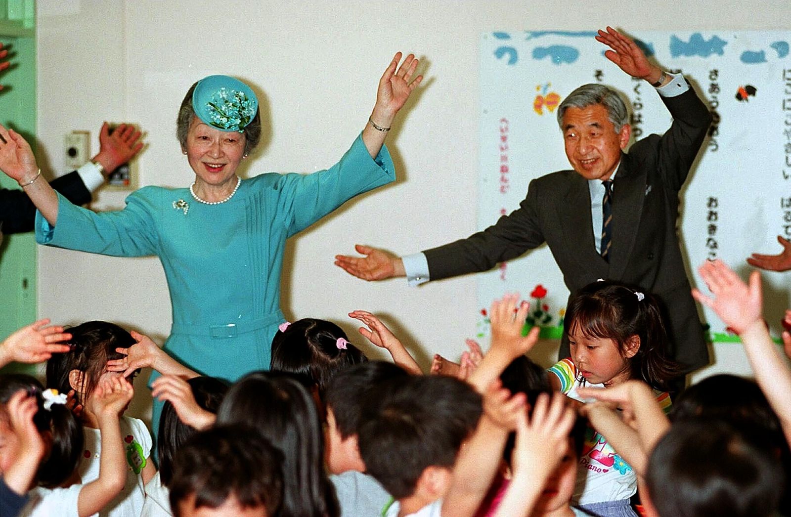 AFP-ราชวงศ์ญี่ปุ่น-จักรพรรดิอะกิฮิโตะ-จักรพรรดินีมิชิโกะร้องเพลงและเต้นรำร่วมกับเด็กๆ ในโรงเรียน.jpg